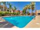 Community pool featuring cool blue water, sun loungers, and palm trees in view at 3500 N Hayden Rd # 2103, Scottsdale, AZ 85251