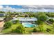 Aerial view of the home with a pool, surrounded by lush trees and greenery in the backyard at 370 E Redfield Rd, Chandler, AZ 85225