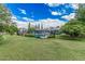 Wide green backyard with pool area enclosed by a metal fence, and mature trees at 370 E Redfield Rd, Chandler, AZ 85225