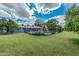 Wide green backyard with pool area enclosed by a metal fence, home and landscaping at 370 E Redfield Rd, Chandler, AZ 85225