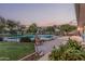Fenced pool area featuring a stone waterfall and lush landscaping at 370 E Redfield Rd, Chandler, AZ 85225