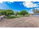 Gravel area with green lawn and a partially obstructed view of the pool and slide in the background at 370 E Redfield Rd, Chandler, AZ 85225