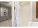 Cozy bathroom featuring a walk-in shower with a charming floral curtain at 370 E Redfield Rd, Chandler, AZ 85225