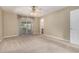 Bedroom with a ceiling fan, access to a bathroom and a glass door leading to a patio at 370 E Redfield Rd, Chandler, AZ 85225