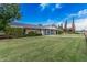 Spacious home with a lush lawn, blue siding, brick accents, and a well-manicured landscape at 370 E Redfield Rd, Chandler, AZ 85225