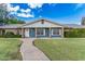 Attractive home with a curved brick pathway, lush green lawn, and classic blue and brick exterior at 370 E Redfield Rd, Chandler, AZ 85225