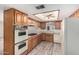 Cozy kitchen with wood cabinets, white appliances, and recessed ceiling lighting at 370 E Redfield Rd, Chandler, AZ 85225