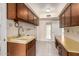 Functional kitchen features wood cabinets, tiled floors, and a bright sink area at 370 E Redfield Rd, Chandler, AZ 85225