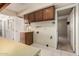 Laundry area with wood cabinets and tile floors, offering practicality and storage at 370 E Redfield Rd, Chandler, AZ 85225