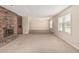 Spacious living room featuring a brick fireplace, built-in shelving, and neutral carpeting at 370 E Redfield Rd, Chandler, AZ 85225