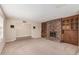 Spacious living room featuring a brick fireplace, built-in shelving, and neutral carpeting at 370 E Redfield Rd, Chandler, AZ 85225