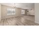 Bright living room featuring wood-look flooring and large windows at 370 E Redfield Rd, Chandler, AZ 85225