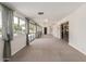 Bright living space with carpet, natural light, and glass sliding doors to exterior at 370 E Redfield Rd, Chandler, AZ 85225