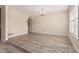 Spacious living room featuring a decorative chandelier and modern wood-look flooring at 370 E Redfield Rd, Chandler, AZ 85225