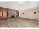Spacious living room with a brick fireplace, built-in cabinets, and wood-look floors at 370 E Redfield Rd, Chandler, AZ 85225