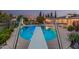 Pool with diving board, with a fence line and lush greenery at 370 E Redfield Rd, Chandler, AZ 85225