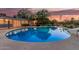 Inviting fenced pool featuring clear blue water and surrounded by lush landscaping at 370 E Redfield Rd, Chandler, AZ 85225