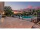 Fenced backyard pool area with mature trees and a slide for fun activities at 370 E Redfield Rd, Chandler, AZ 85225
