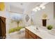 Bright bathroom featuring a shower with a tree-themed curtain, decorative mirrors, and a well-lit vanity area at 39006 N Habitat Circle Cir, Cave Creek, AZ 85331