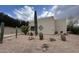 Desert-landscaped front yard with cacti and gravel surrounding a modern, light-colored house under a partly cloudy sky at 39006 N Habitat Circle Cir, Cave Creek, AZ 85331