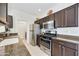 Efficient kitchen design features stainless steel appliances and dark cabinets, well-lit and spacious at 39006 N Habitat Circle Cir, Cave Creek, AZ 85331