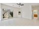 Bright living room with tile flooring, a ceiling fan, a sliding glass door, and a decorative built-in shelf at 39006 N Habitat Circle Cir, Cave Creek, AZ 85331