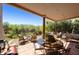 Inviting covered outdoor patio with stylish furniture and tranquil views of desert landscape at 39006 N Habitat Circle Cir, Cave Creek, AZ 85331