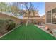 Well-maintained backyard features lush green lawn, mature trees, and privacy fence at 4002 E Melinda Ln, Phoenix, AZ 85050