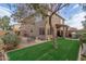 Spacious backyard boasts green lawn, privacy fencing, patio area, and desert landscaping at 4002 E Melinda Ln, Phoenix, AZ 85050