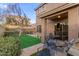 Backyard features green lawn, patio area, desert landscaping, and cozy outdoor dining set at 4002 E Melinda Ln, Phoenix, AZ 85050