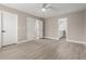 Spacious bedroom with light wood floor, ceiling fan, and ensuite bath access at 4002 E Melinda Ln, Phoenix, AZ 85050