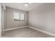 Cozy bedroom with light wood floors, a window, and closet with sliding doors at 4002 E Melinda Ln, Phoenix, AZ 85050