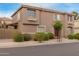 Inviting townhome with a well-kept exterior, featuring manicured bushes and neutral tones at 4002 E Melinda Ln, Phoenix, AZ 85050