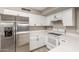 Modern kitchen with stainless steel appliances, white cabinets, and light countertops at 4002 E Melinda Ln, Phoenix, AZ 85050