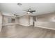 Open living space with light wood flooring, two ceiling fans, and ample natural light at 4002 E Melinda Ln, Phoenix, AZ 85050