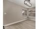 This living room has two windows with blinds and a modern light fixture at 4002 E Melinda Ln, Phoenix, AZ 85050