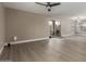 Spacious living room with neutral walls, ceiling fan, and sliding glass doors for natural light at 4002 E Melinda Ln, Phoenix, AZ 85050