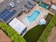 Bird's eye view of the backyard featuring a pool, shaded pergola, solar panels, and outdoor dining space at 4408 N 28Th Pl, Phoenix, AZ 85016
