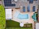 Aerial view of a backyard oasis with pool, pergola, solar panels, and lush landscaping, offering a private retreat at 4408 N 28Th Pl, Phoenix, AZ 85016