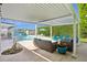 Relaxing backyard with covered patio seating, a sparkling pool, and lush green landscaping for outdoor enjoyment at 4408 N 28Th Pl, Phoenix, AZ 85016