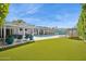 Spacious backyard features a pool, green turf, covered patio, and manicured landscaping, perfect for entertaining and relaxing at 4408 N 28Th Pl, Phoenix, AZ 85016