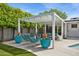 Serene backyard with a pergola-covered seating area, lounge chairs, and lush greenery, providing a peaceful outdoor escape at 4408 N 28Th Pl, Phoenix, AZ 85016