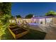 A stunning backyard oasis with a sparkling pool, lush greenery, and a cozy seating area with outdoor furniture at 4408 N 28Th Pl, Phoenix, AZ 85016