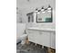 Elegant bathroom with double sinks, modern fixtures, and decorative tile flooring at 4408 N 28Th Pl, Phoenix, AZ 85016