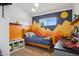 bedroom features a mountain mural, wood bedframe, and neutral flooring at 4408 N 28Th Pl, Phoenix, AZ 85016