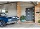 Exterior elevation showcasing covered parking and a striking blue car beside a modern home entry at 4408 N 28Th Pl, Phoenix, AZ 85016