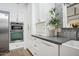 Contemporary kitchen features stainless steel appliances and sleek white cabinetry at 4408 N 28Th Pl, Phoenix, AZ 85016