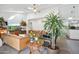 Open concept living room with comfortable leather seating, indoor plants, and a view of the dining area at 4408 N 28Th Pl, Phoenix, AZ 85016