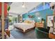 Main bedroom with blue accent wall, wooden furniture, and backyard access at 4408 N 28Th Pl, Phoenix, AZ 85016