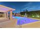 Nighttime view of the backyard with a pool, patio, chairs, and lounge chairs at 4408 N 28Th Pl, Phoenix, AZ 85016